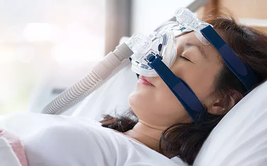 Woman using CPAP machine